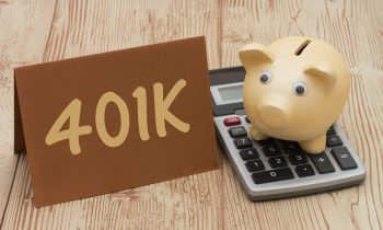 Having A 401K Plan, A Golden Piggy Bank, Card And Calculator On