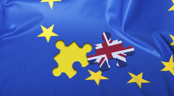 Brexit - Detail of Silky Flag of Blue European Union EU Flag Drapery With Puzzle Piece With Great Britain