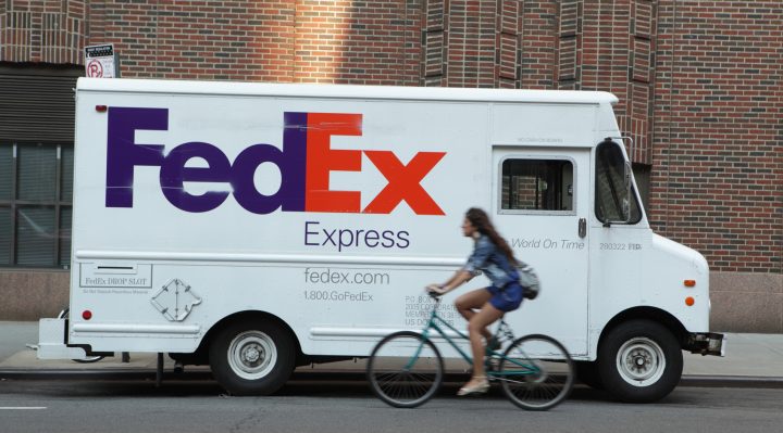 FedEx delivery truck with blurred NYC cyclist cycling